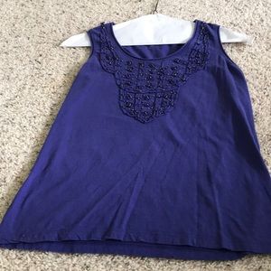 Sleeveless knit top with bead embellishments.